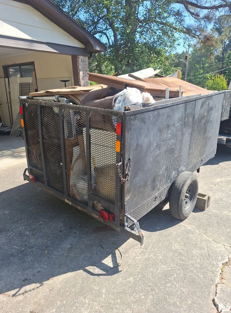 KLR Pro Services hauling trailer loaded with debris
